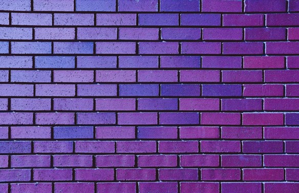 a purple brick wall portraying the idea of writer's block
