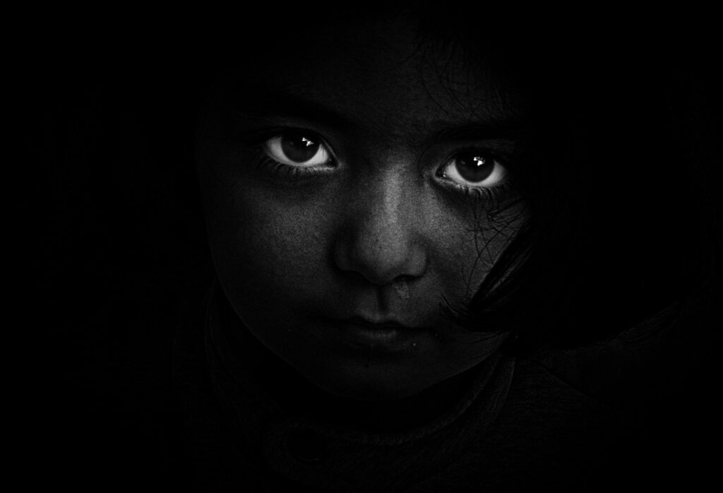 visual design mostly black image with dramatic white eyes