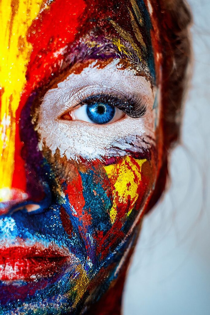 female face painted in bright colors