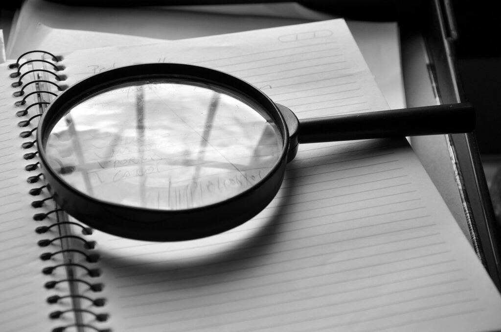 magnifying glass; find a literary agent concept