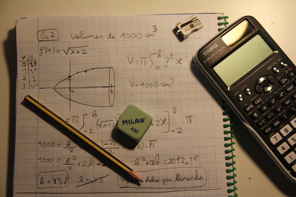 calculator and math equations on notebook; social media math doesn't add up concept