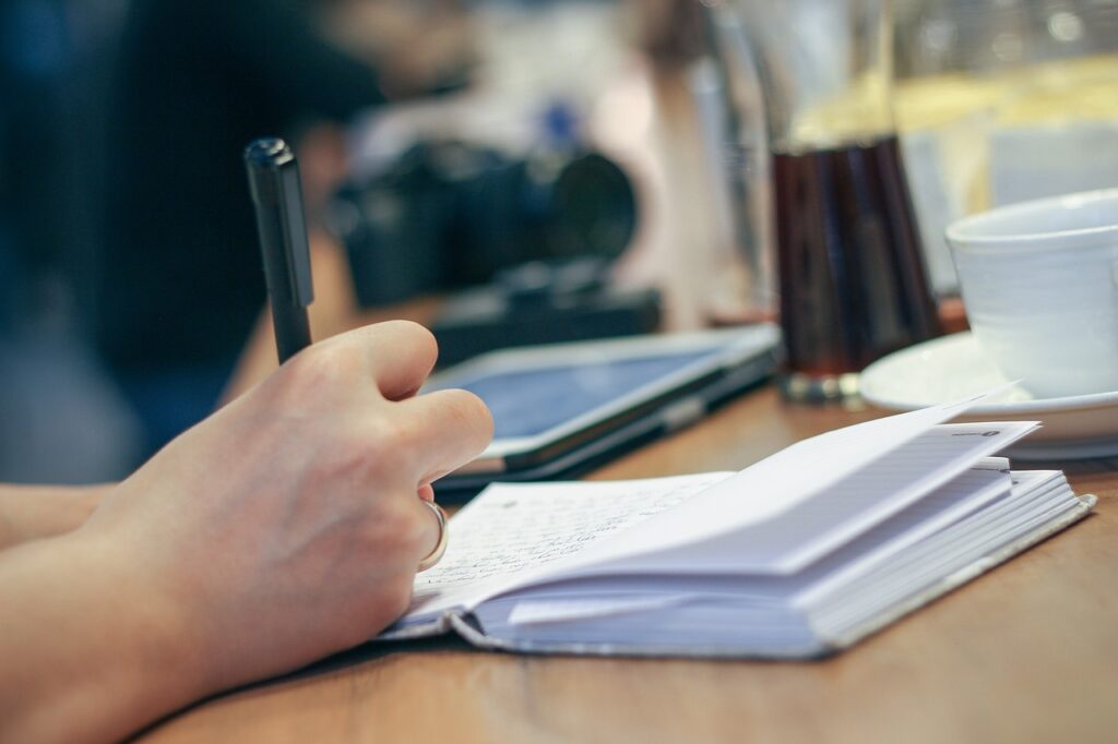 Writer writing in a coffee shop, genius ideas