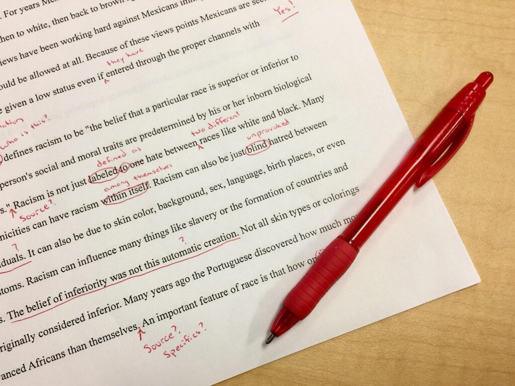 proofreading; document marked up with red pen